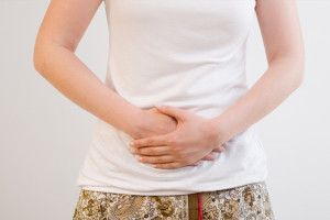 woman-holding-stomach-in-pain